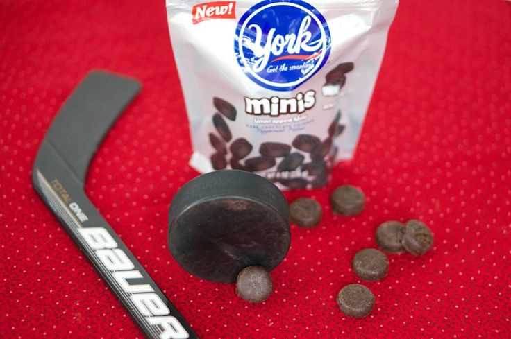 a bag of chips next to an ice cream scooper and some chocolate chips on a red surface