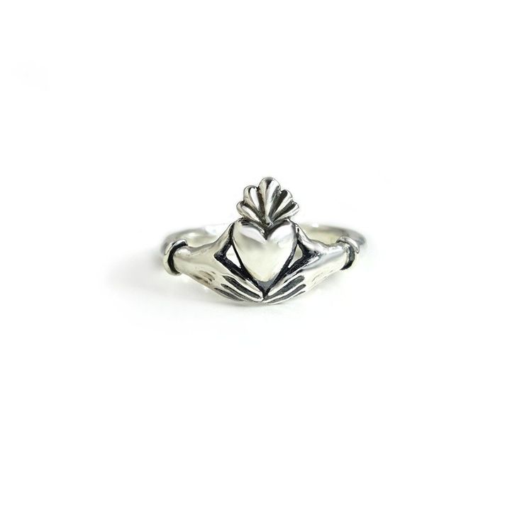 This Claddagh Ring in sterling silver is an original design for my friend Lily's wedding ring. I liked it so much I decided to offer it to others. It is a delicate rendition of the traditional claddagh ring with delicate, feminine hands and wrists. Each wrist wears a single bracelet, opposed to the usual cuff. The hands are fully 3D, and hold the edges of the heart in a realistic way. Oxidized in the crevices to bring out the details, and highly polished throughout. The band measures approximate Hand Cast Sterling Silver Engraved Ring For Wedding, Sterling Silver Heirloom Heart Ring For Promise, Classic Sterling Silver Open Heart Ring, Heirloom Sterling Silver Heart Ring For Promise, Heirloom Sterling Silver Hand Cast Jewelry, Heirloom Hand Cast Sterling Silver Jewelry, Sterling Silver Heart Promise Ring, Sterling Silver Heart Ring With Polished Finish For Wedding, Classic Sterling Silver Hand Cast Rings