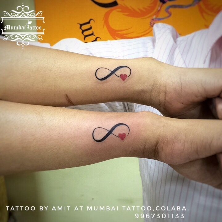 two people with matching tattoos on their arms, both have hearts and an infinite symbol