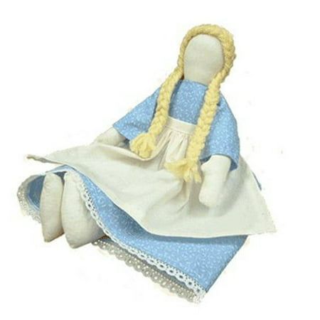 a stuffed doll is sitting on top of two cloths and wearing a blue dress