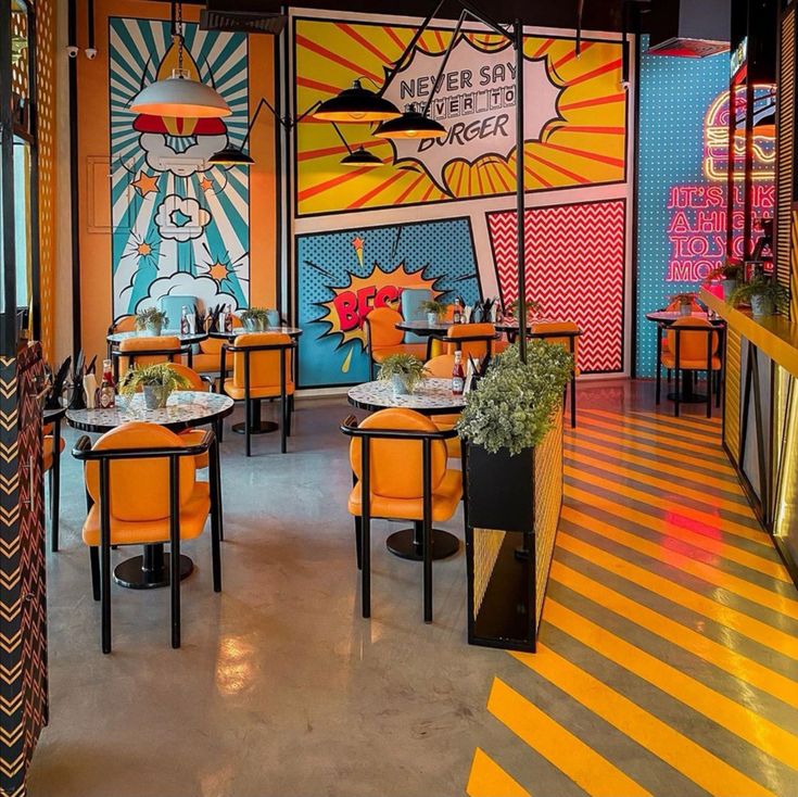 the interior of a restaurant with brightly colored walls and tables, decorated in bright colors