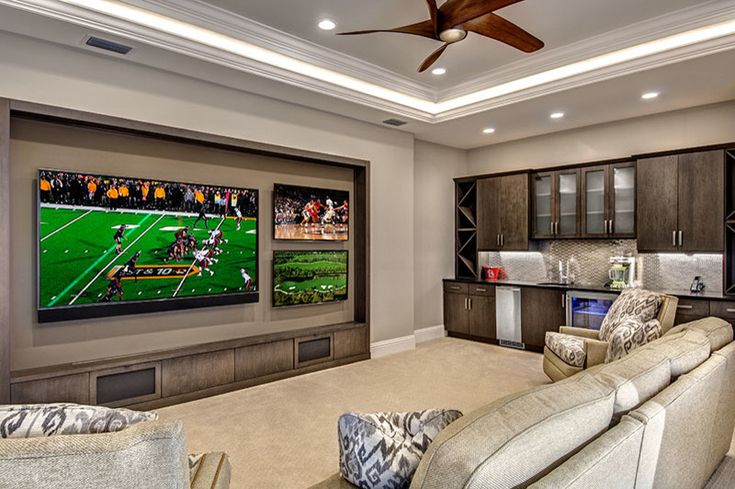 a living room filled with furniture and a flat screen tv mounted to the side of a wall