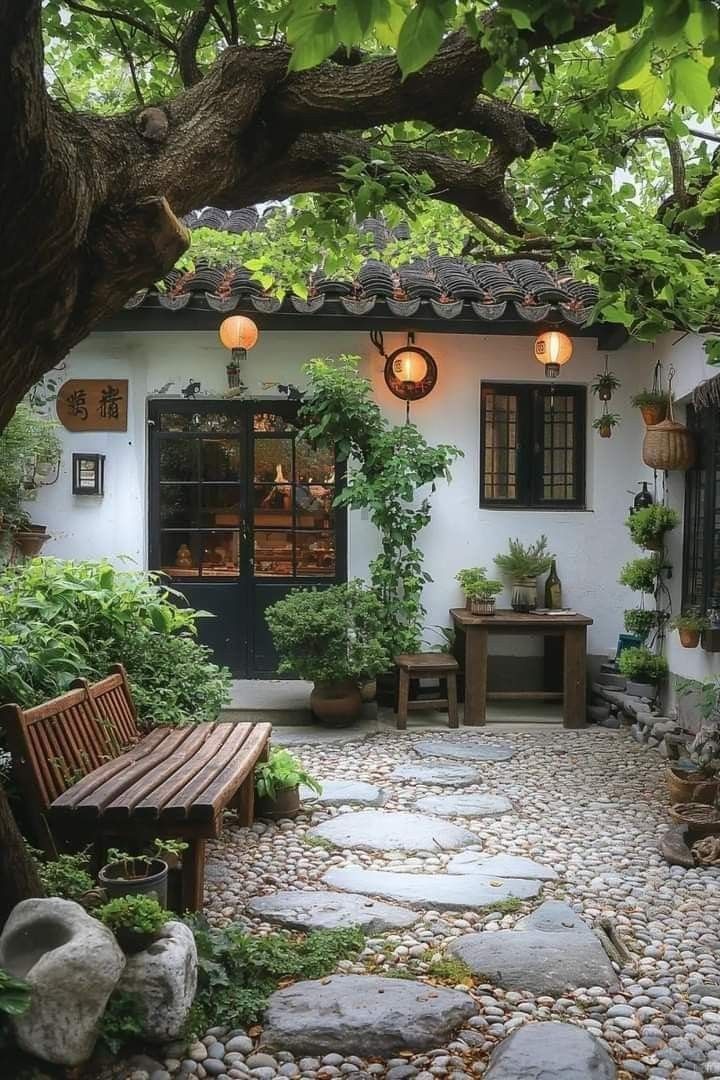 a small courtyard with a bench and potted plants on the outside, surrounded by trees