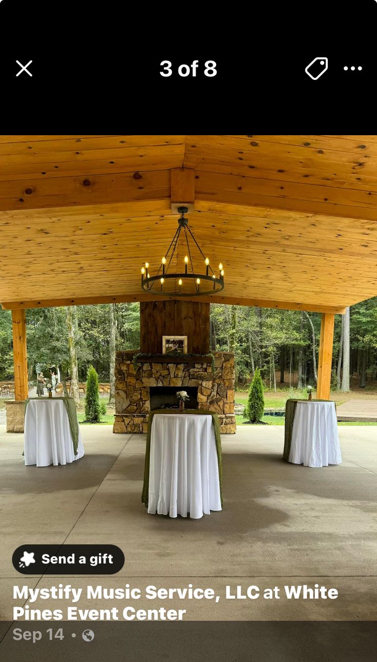 the inside of a tent with tables and white tablecloths