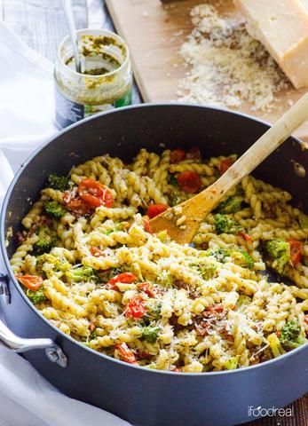 a pot filled with pasta and vegetables on top of a table