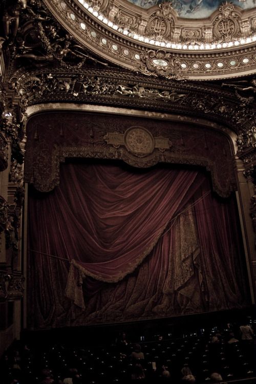 an ornately decorated stage with red curtains