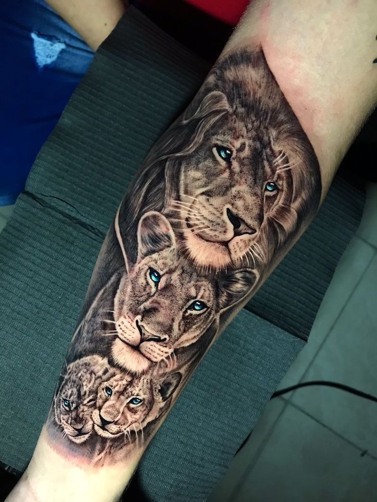 a man with a tattoo on his arm that has three lions and two cubs in it