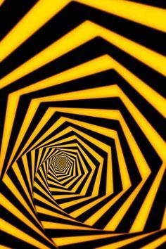 a black and yellow tunnel with only one light at the end