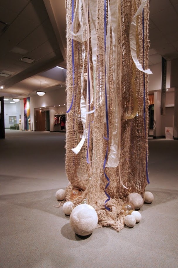 there are balls and streamers hanging from the ceiling