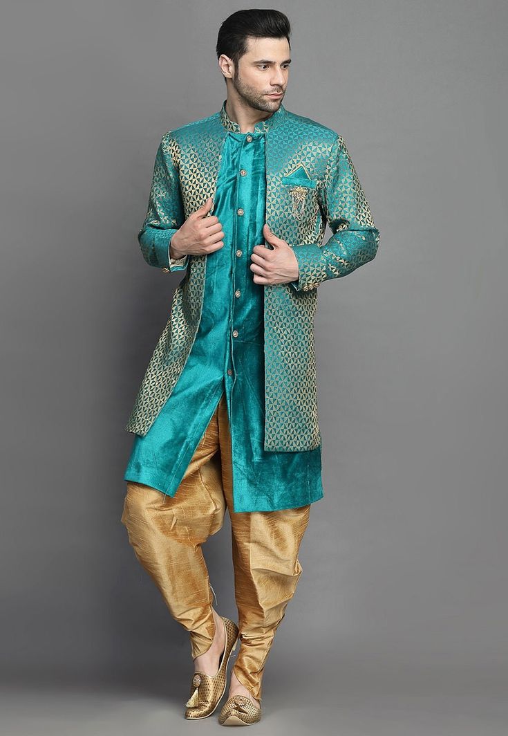 Art Brocade Silk and Art Silk Layered Sherwani in Teal BlueThis Readymade attire is Enhanced with Buttons. Crafted in Chinese Collar Neck and Full SleeveAvailable with an Art Silk Dhoti Pant in BeigeDo note: Brooch and Footwear shown in the image is for presentation purposes only. Half to one inch may vary in measurement. (Slight variation in actual color vs. image is possible) We sell all kinds of menswear. Mens Kurta | Mens Kurta Pajama | Mens Sherwani | Mens Sherwani Sets | Traditional Menswe Blue Traditional Drape Kurta With Dupatta, Blue Kurta With Dupatta In Traditional Drape, Blue Semi-stitched Kurta With Traditional Drape, Blue Straight Kurta Bandhgala For Navratri, Blue Bandhgala For Navratri Designer Wear, Blue Long Sleeve Choli With Dupatta, Blue Traditional Wear With Dabka For Navratri, Blue Dabka Traditional Wear For Navratri, Blue Traditional Wear With Dabka In Art Silk