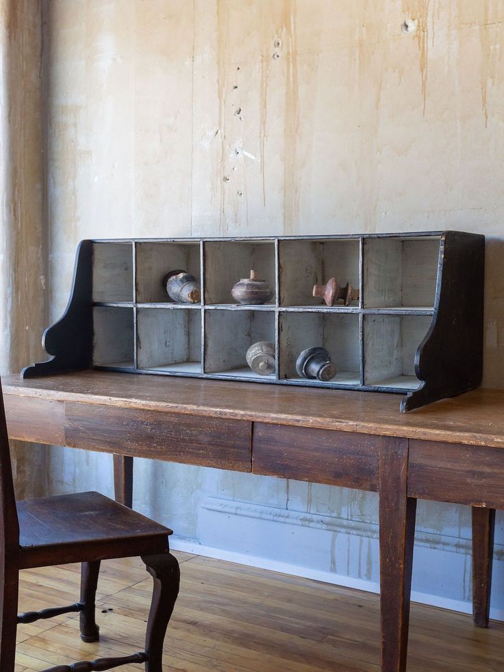 a wooden table topped with lots of metal containers