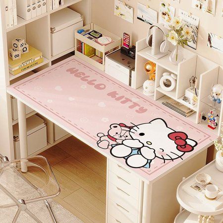 a desk with a hello kitty rug on it