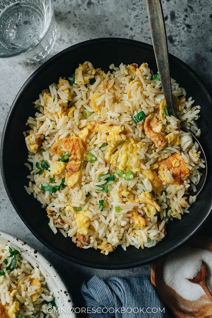 a bowl filled with rice and meat on top of a table