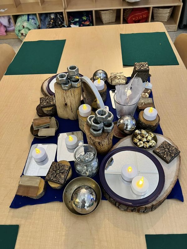 a table topped with lots of different types of dishes and candles on top of it