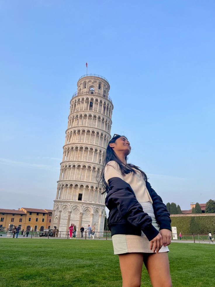 a woman standing in front of the leaning tower