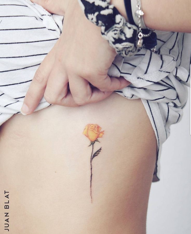 a woman with a flower tattoo on her stomach