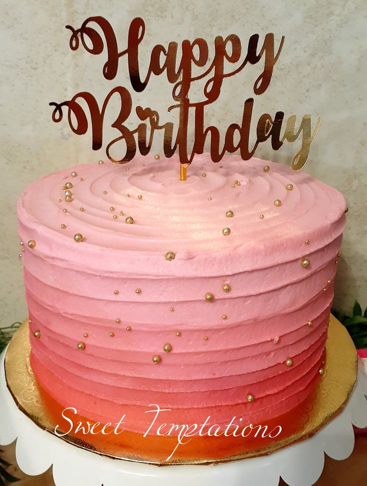 a birthday cake with pink and red frosting