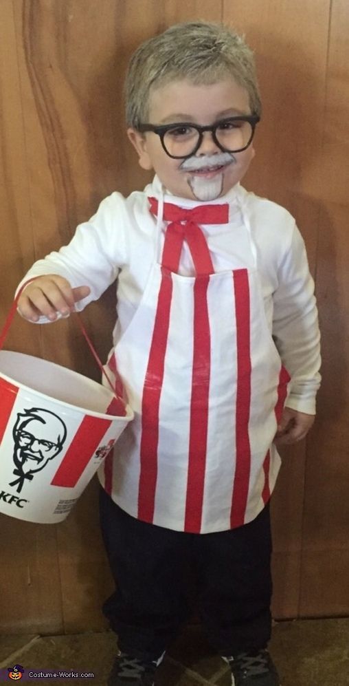 a little boy dressed up as a movie character holding a bucket and wearing eyeglasses