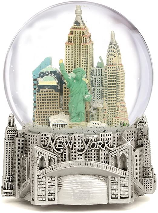 a snow globe with the statue of liberty in new york, ny on it's base