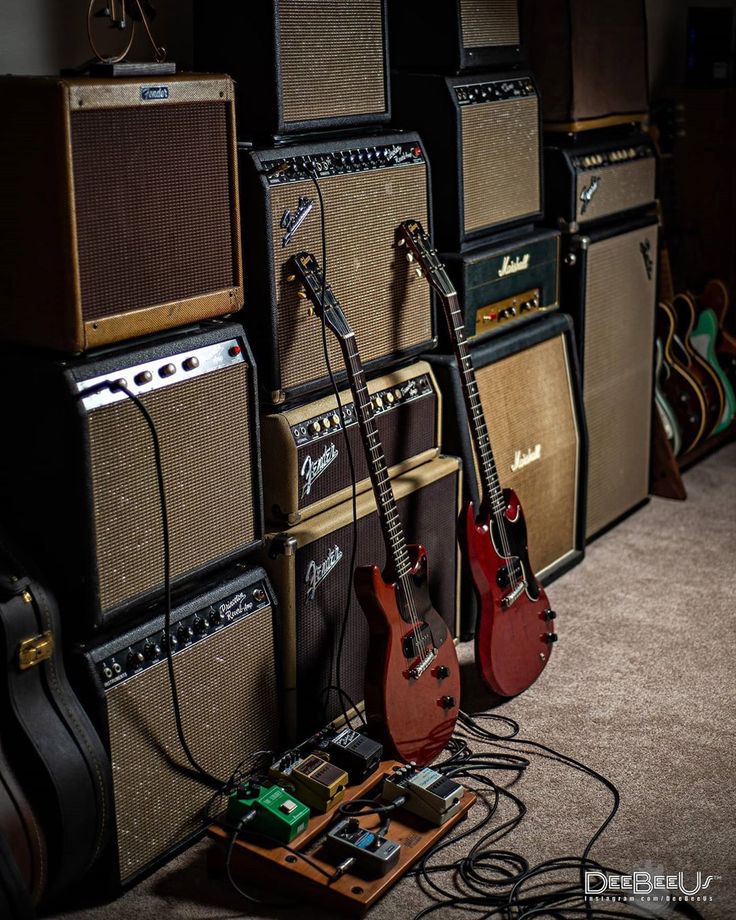 guitars and amps are lined up on the floor