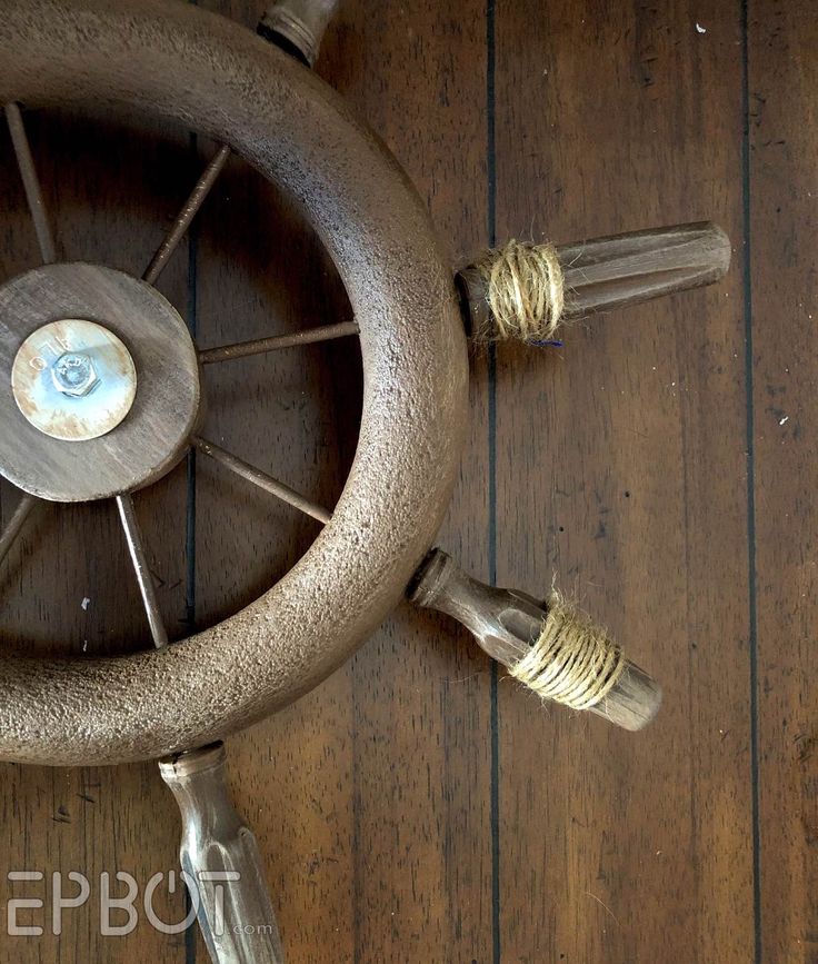 an old spinning wheel with two spools of thread on the floor next to it