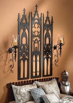 an ornate iron headboard with candles on it