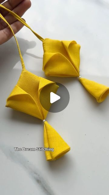 someone is making origami pieces out of yellow paper