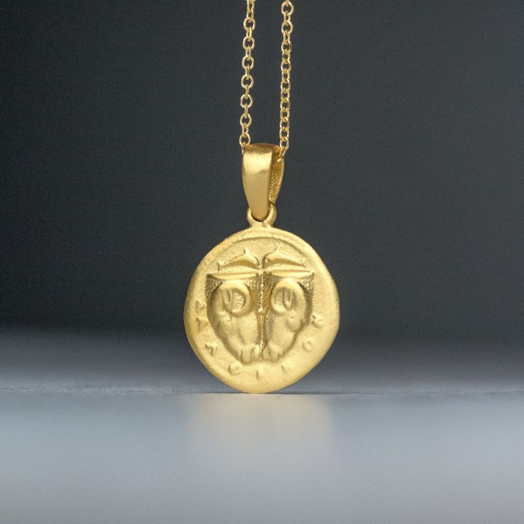 Solid gold ancient Greek coin necklace, inspired by the 5th century BC Delphi coin (Phokis). There is an image on both sides and can be worn either way. It pictures two rhyta (drinking vessels) in the form of ram's heads, above, two dolphins are swimming toward each other; ΔAΛΦ-I-KON in small letters below on the other side, the backside, it pictures a Quadripartite incuse square in the form of a coffered ceiling; each coffer decorated with a dolphin and laurel spray. This is a replica of an anc Handmade Yellow Gold Coin Amulet Necklace, Handmade Yellow Gold Amulet Coin Necklace, Symbolic Yellow Gold Coin Medallion Necklace, Symbolic Yellow Gold Coin Necklace, 14k Gold Amulet Coin Necklace Tarnish Resistant, Yellow Gold Symbolic Engraved Coin Necklace, Symbolic Yellow Gold Plated Coin Necklace, Symbolic Gold Plated Coin Necklace In Yellow Gold, Yellow Gold Byzantine Necklace With Coin Pendant