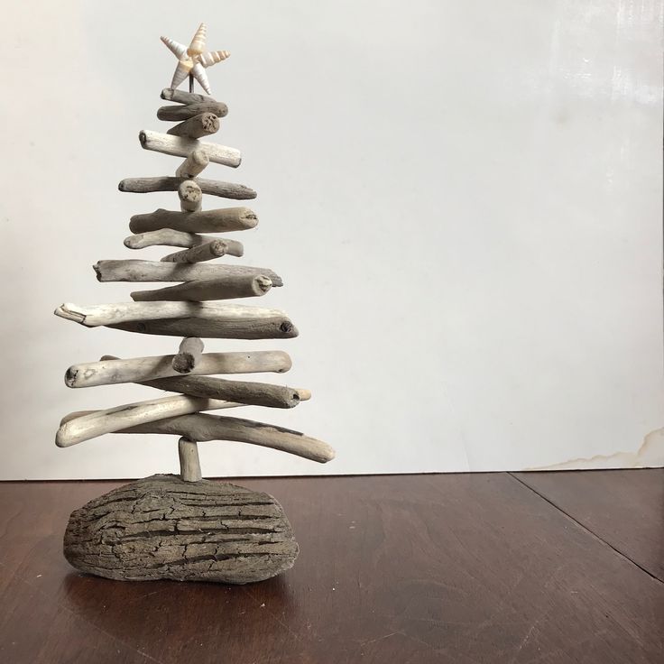 a tree made out of driftwood sitting on top of a wooden table