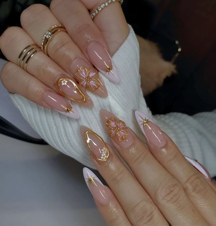 a woman's hands with pink and gold manies