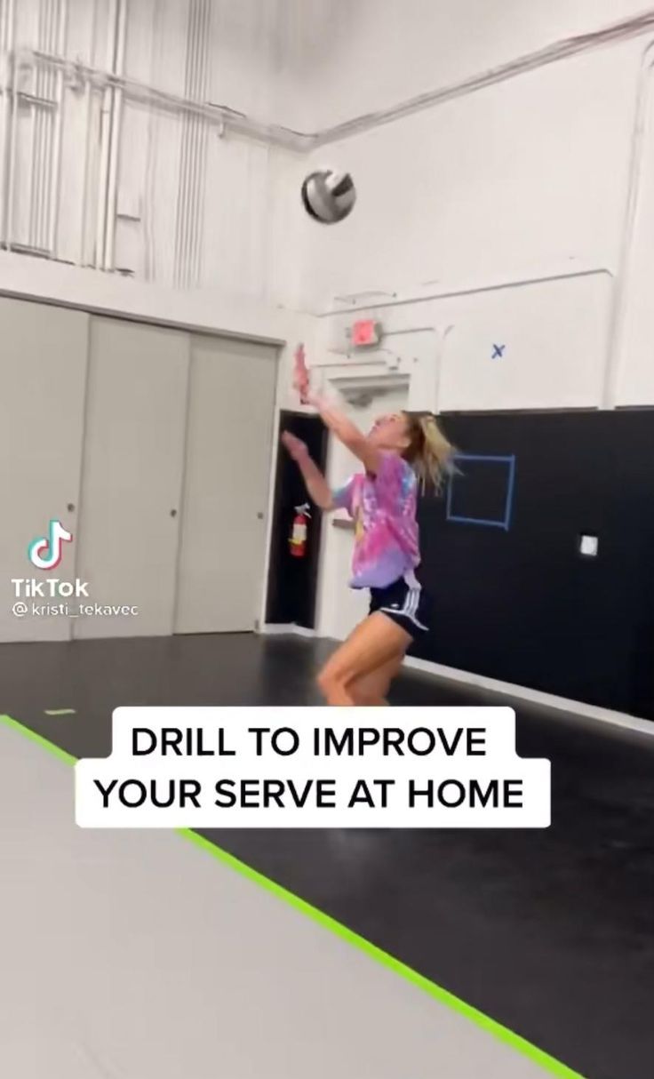 a girl jumping up in the air to catch a frisbee on a trampoline