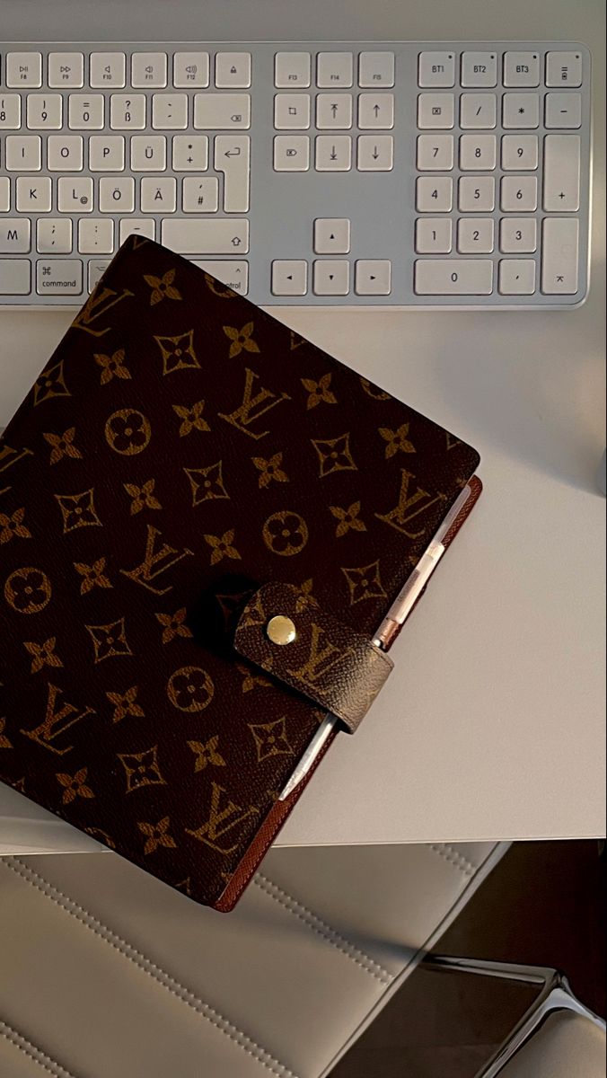 a notebook sitting on top of a desk next to a keyboard