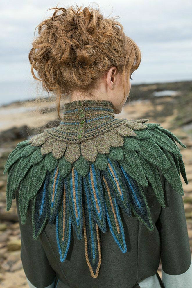 the back of a woman's jacket with feathers on her neck and shoulders,