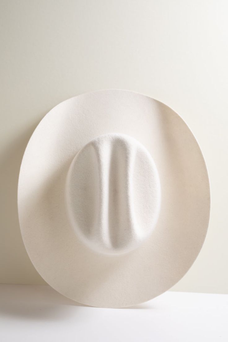 Add a touch of cowgirl to any look with our curled brim wool Rider hat in a versatile, ivory color. Book a virtual session with one of our stylists to customize your hat band and make it uniquely you. Details: 100-percent Australian wool Crown 4" Brim 4" Hidden adjustable band for fit flexibility Size chart Return policy Western White Top Hat With Flat Brim, Western Style White Top Hat With Flat Brim, White Western Top Hat With Flat Brim, Fitted White Felt Hat With Wide Brim, Fitted White Wide Brim Felt Hat, White Fitted Wide Brim Felt Hat, White Brimmed Country Top Hat, White Brimmed Country Style Top Hat, Country Style White Brimmed Top Hat