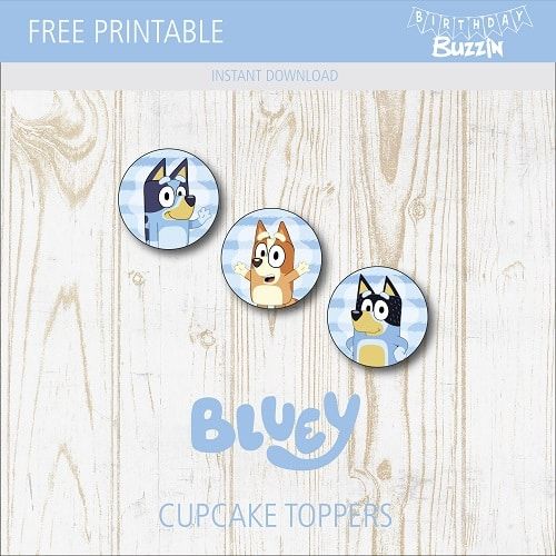 three blue and white buttons with cartoon dogs on them, in front of a wooden background