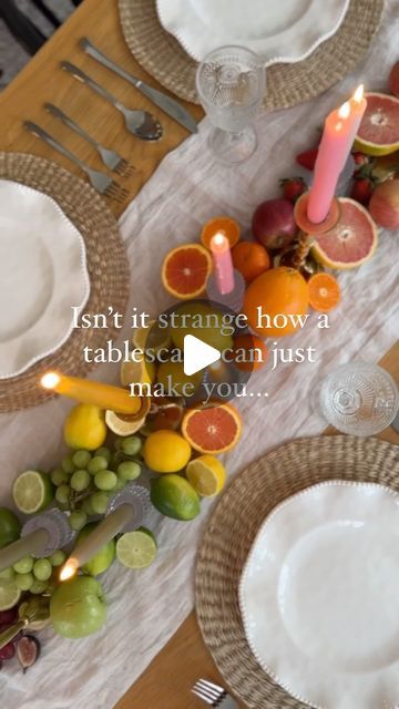 a table set with plates, silverware and fruit on it that says isn't it strange how a tablescape can just make you