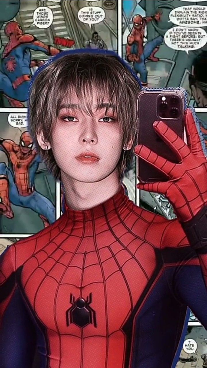 the spider - man is holding up his cell phone