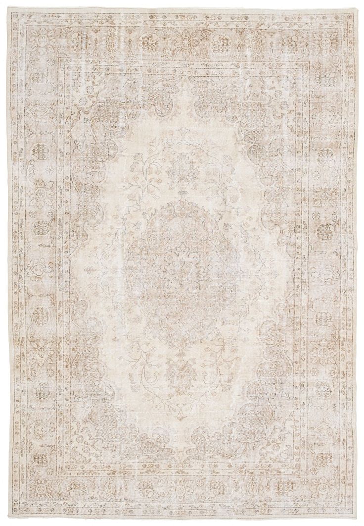 an antique rug with a medallion design in beige and cream colors on a white background