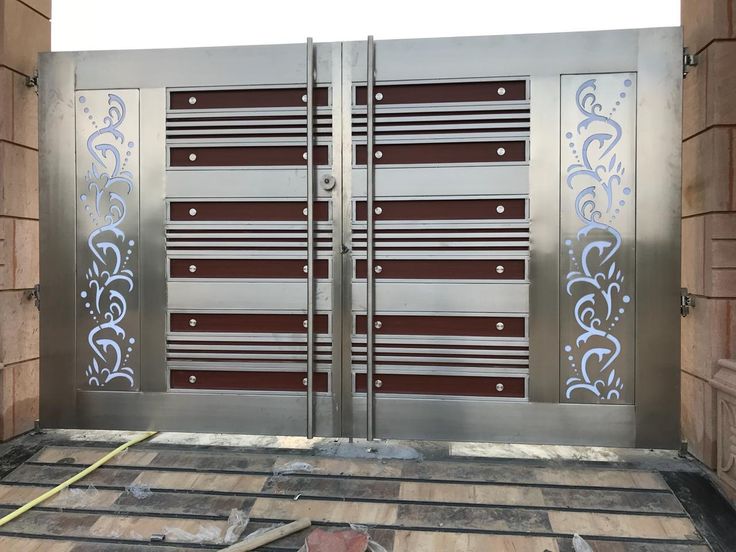 two large metal gates with decorative designs on them