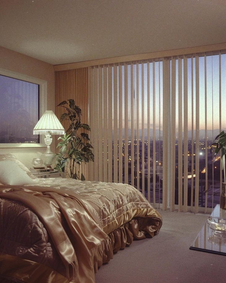 a bedroom with a large window overlooking the city