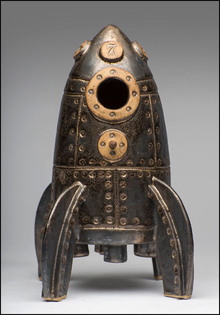 an old fashioned metal object that looks like a rocket ship