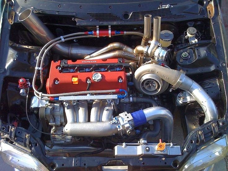 the engine compartment of a car with its hood up and it's hoses out