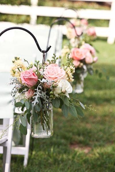 an image of wedding flowers in vases on the back of chairs for aisle decorations