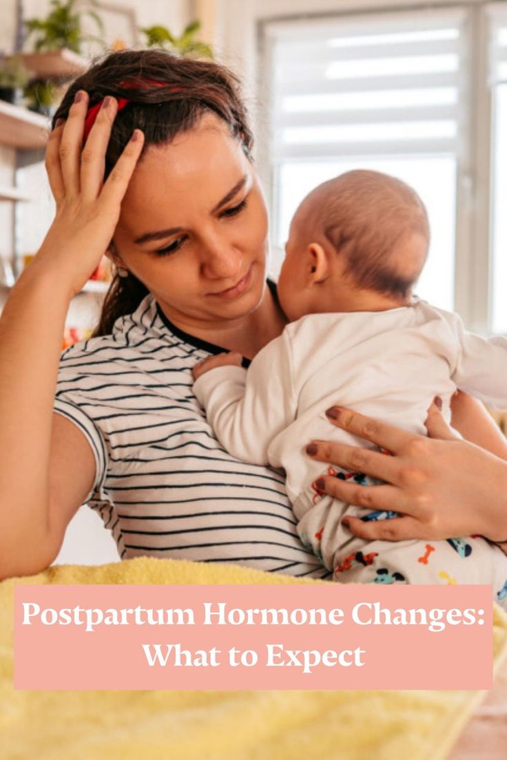 a woman holding a baby with the words postpartum harmon changes what to expect