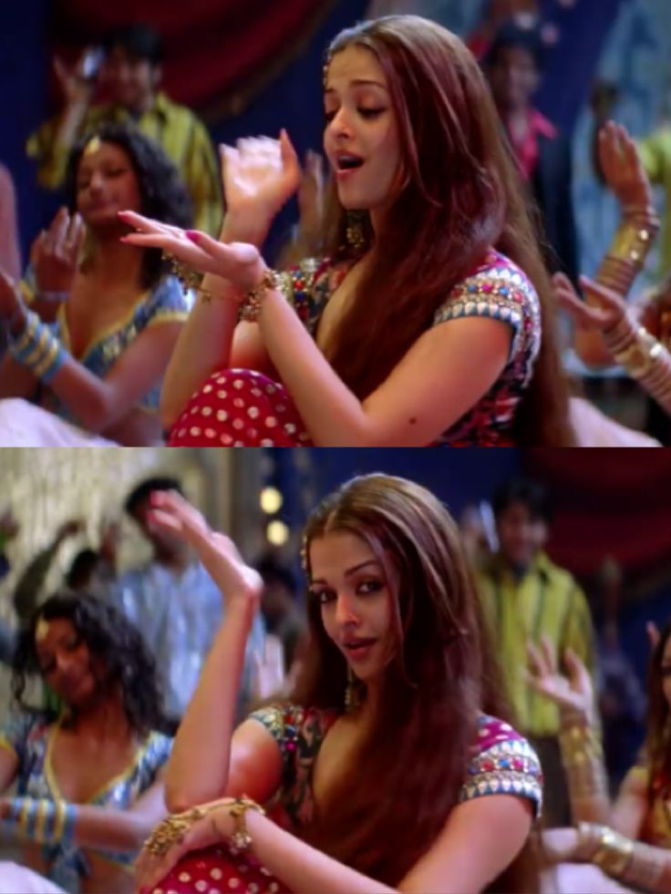 a woman in a red and white dress dancing with her hands out to the side