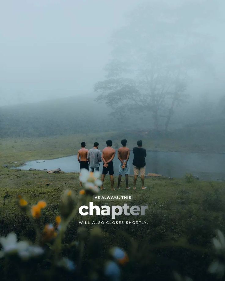 four men standing in front of a body of water on a foggy, misty day