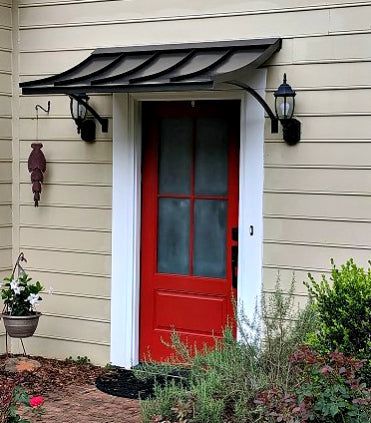 a red front door with an awning over it