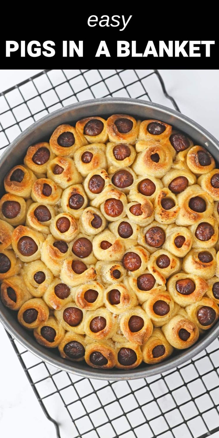 a pan filled with pigs in a blanket on top of a cooling rack