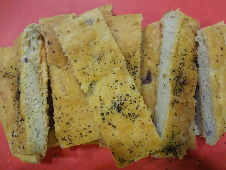 there are several pieces of bread that have been cut in half on a red plate