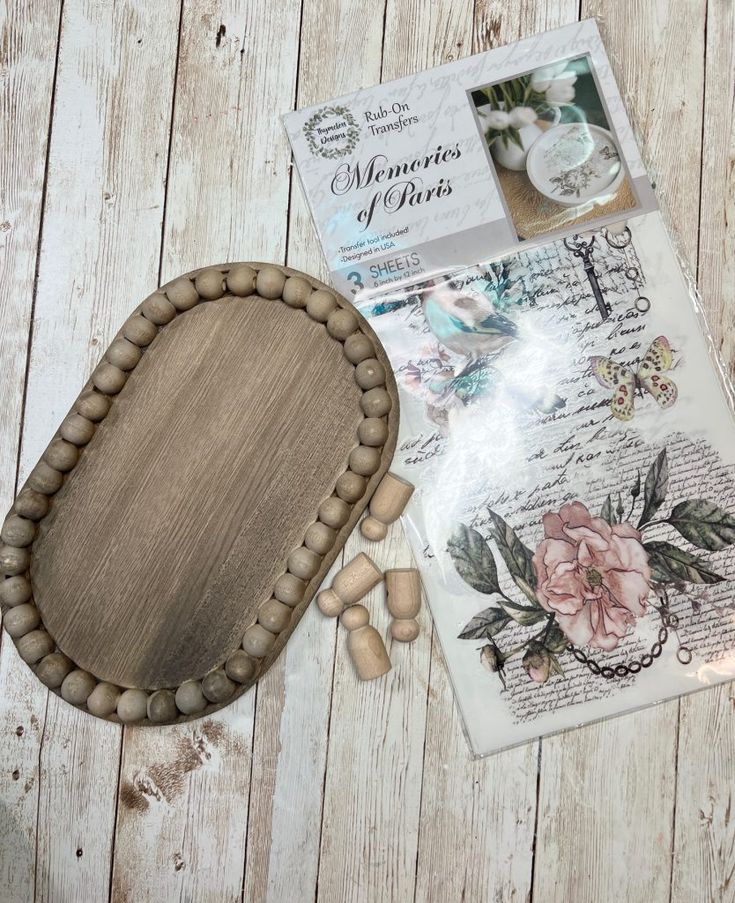 a wooden tray sitting on top of a table next to some paper and other items